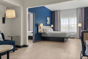 A modern hotel room with a bed, bedside lamps, a desk, and a chair. - City Express By Marriott Gettysburg (Gettysburg)