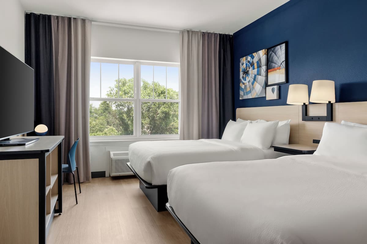 Premium bedding, desk, laptop workspace, blackout curtains