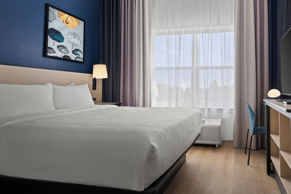 Premium bedding, desk, laptop workspace, blackout curtains