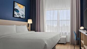 Premium bedding, desk, laptop workspace, blackout drapes
