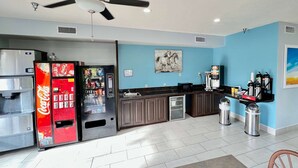 A kitchen with a refrigerator, a microwave, a sink, and a coffee machine. - Days Inn by Wyndham Rayne/Crowley (Rayne)