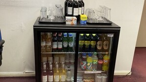 A refrigerator stocked with various beverages including wine, soft drinks, and snacks. - Days Inn by Wyndham Michaelwood M5 (Berkeley)