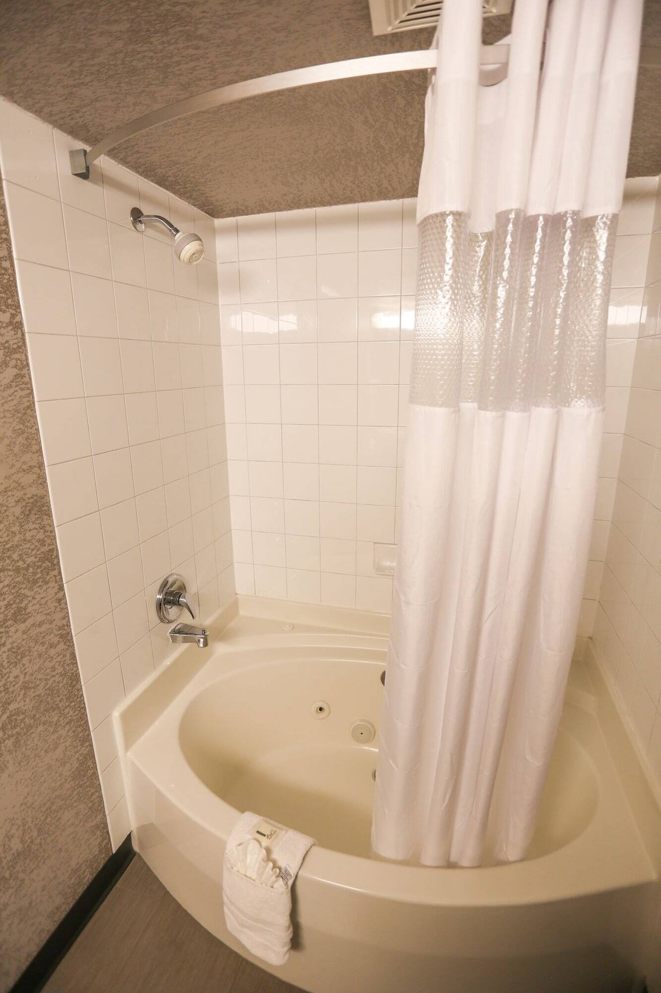 A bathroom with a bathtub, a shower, and a toilet.