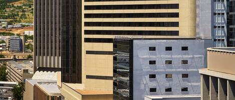 A modern high-rise building with a prominent "Southern Sun" sign, surrounded by other urban structures.