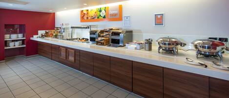 A buffet setup with various food stations, a coffee machine, and a sign indicating 'Express Start'.
