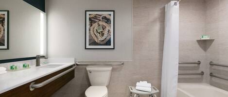 Un baño moderno con inodoro, lavamanos y bañera.