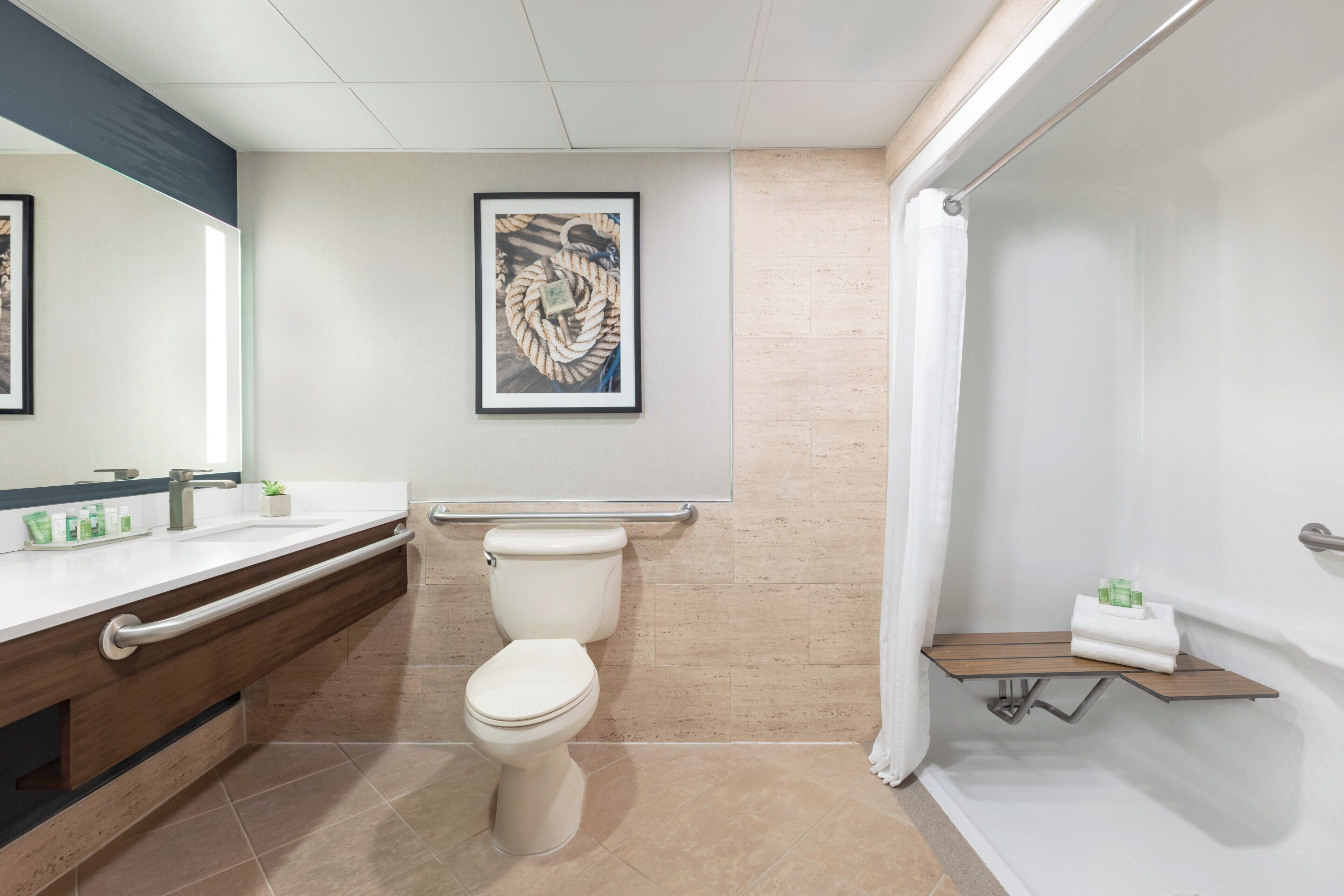 A modern bathroom with a toilet, a sink, and a shower area.