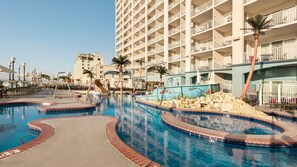 A swimming pool with a dolphin mural, palm trees, and a multi-story hotel building in the background. - Holiday Inn & Suites Ocean City by IHG (Ocean City)