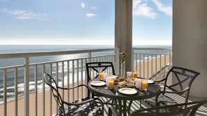 A balcony table with breakfast items and a view of the ocean. - Holiday Inn & Suites Ocean City by IHG (Ocean City)