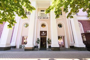 A hotel entrance with a sign reading "HOTEL" and a logo above the door. - Hotel Academy (Dnipro)