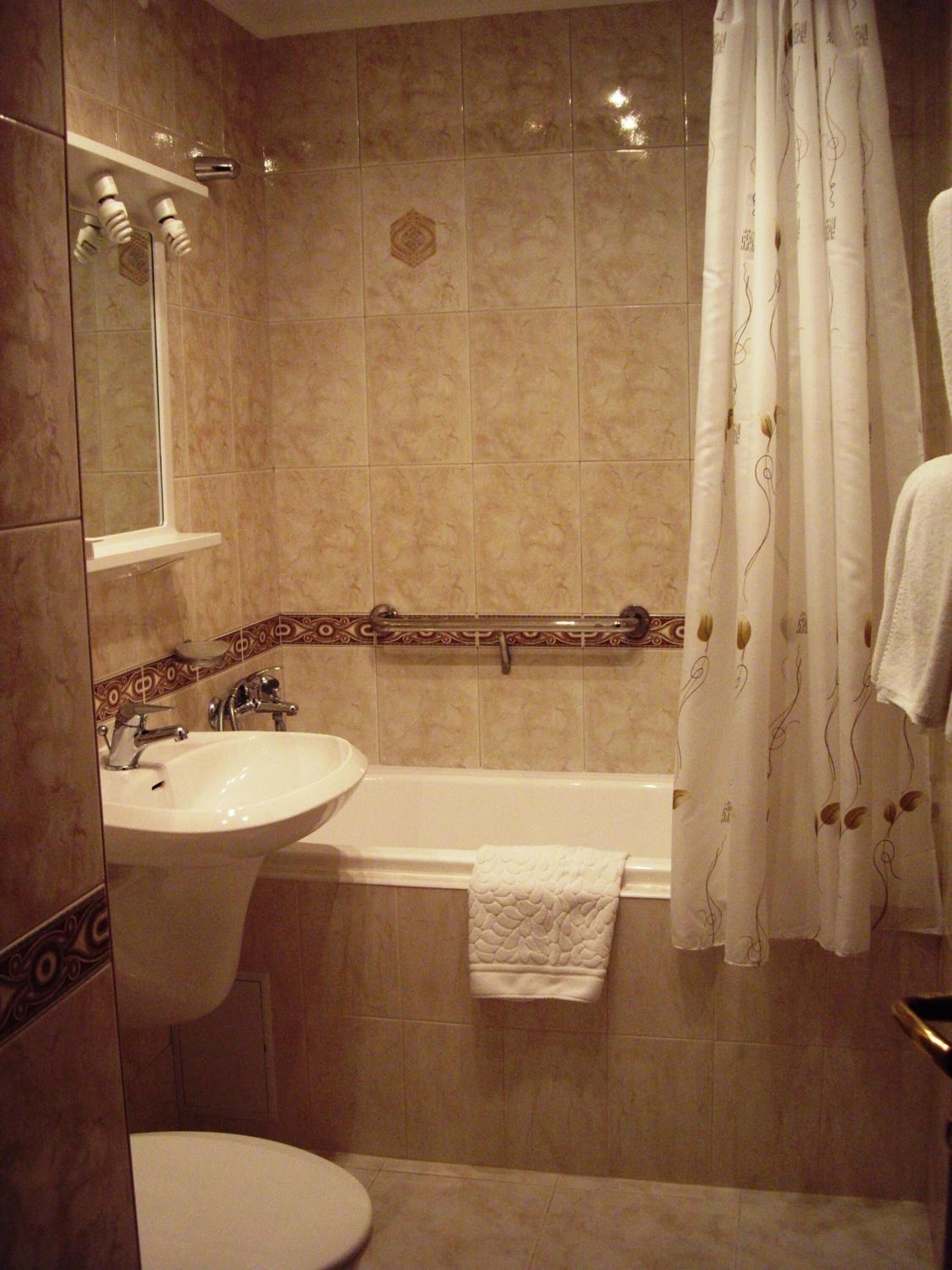 A bathroom with a sink, toilet, and bathtub.