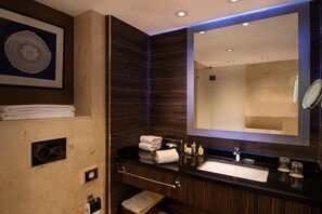 Enjoy a refreshing bathroom experience with a large mirror, black countertop, and white sink.