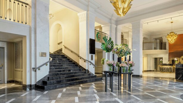 A grand lobby with marble floors, a staircase, and a reception area. - Armenia Marriott Hotel Yerevan (Yerevan)
