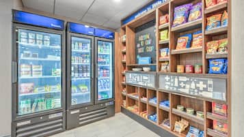 A snack and beverage vending area with two refrigerated units labeled 'frozen' and 'cold'.