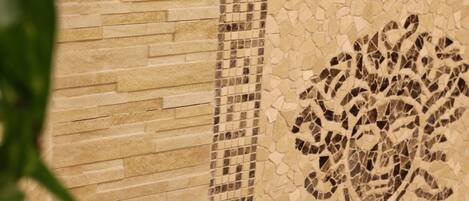 A mosaic tile wall with a geometric pattern.