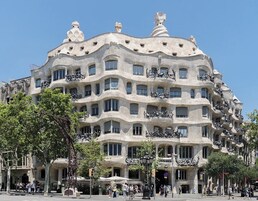 A building with a unique architectural style featuring multiple balconies and a wavy facade.