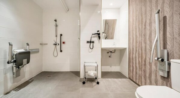 A modern bathroom with a shower, toilet, and sink. - Hotel ILUNION Bel Art (Barcelona)