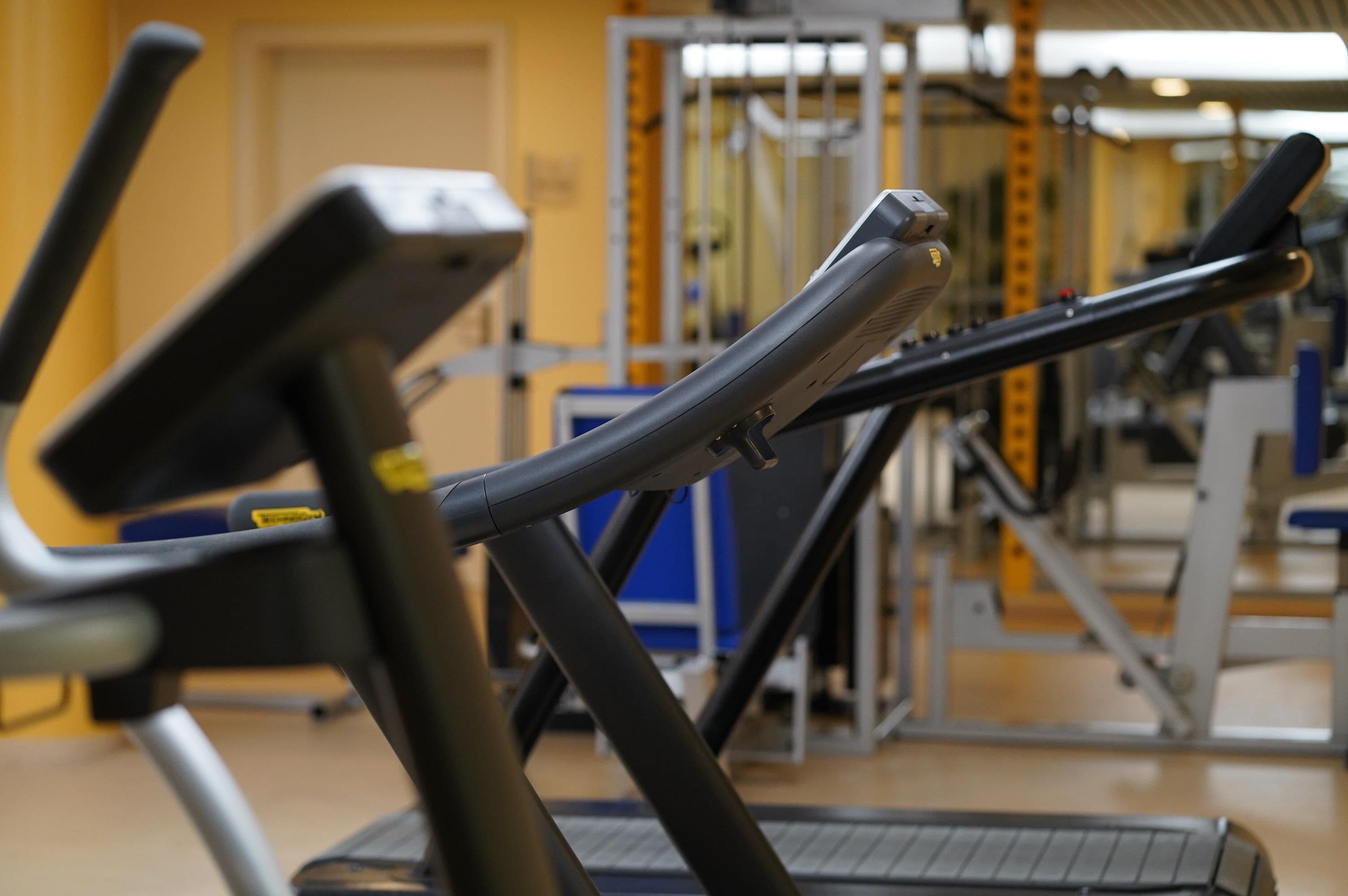 A gym with exercise equipment, including a treadmill and weight machines.