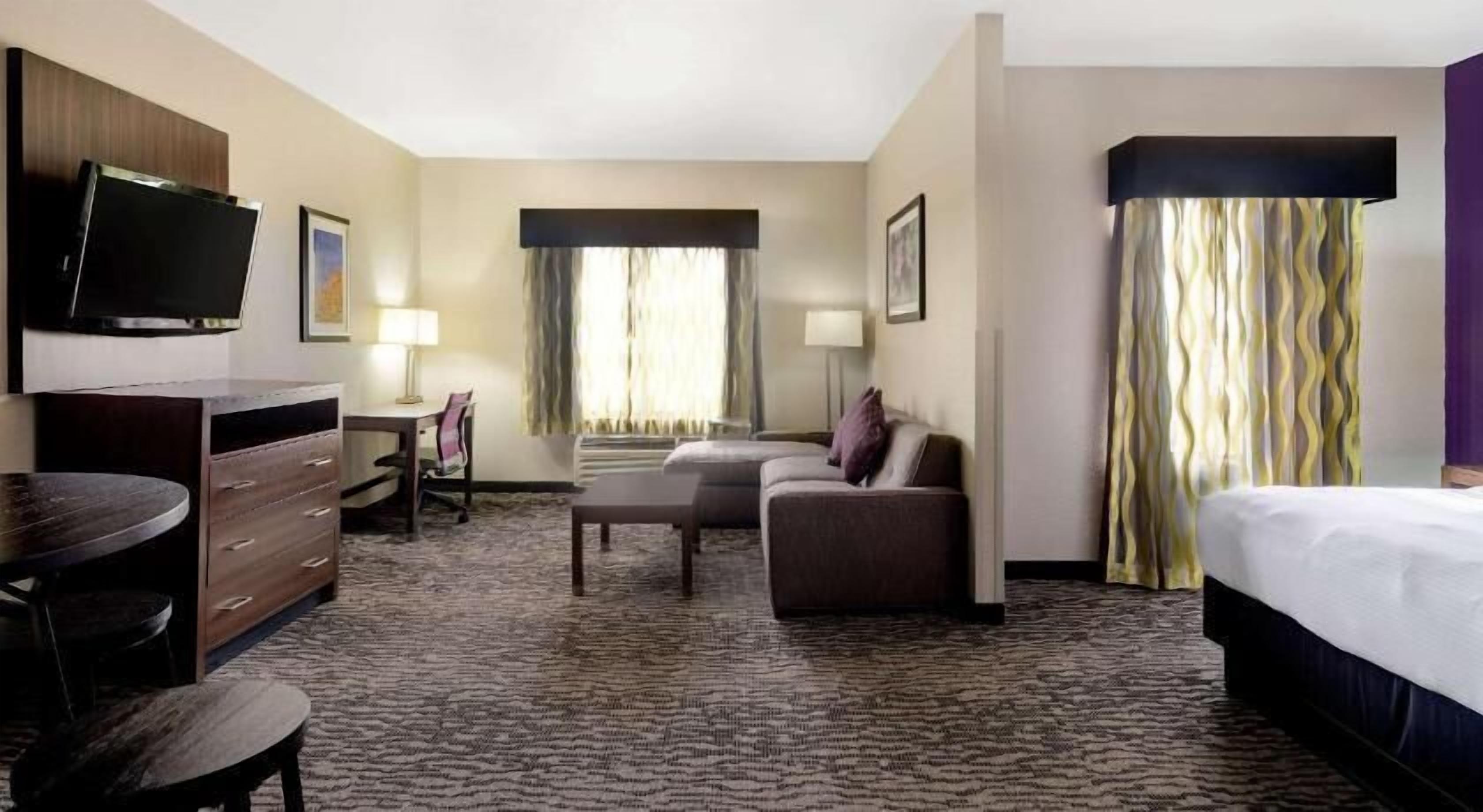 Premium bedding, desk, laptop workspace, blackout curtains