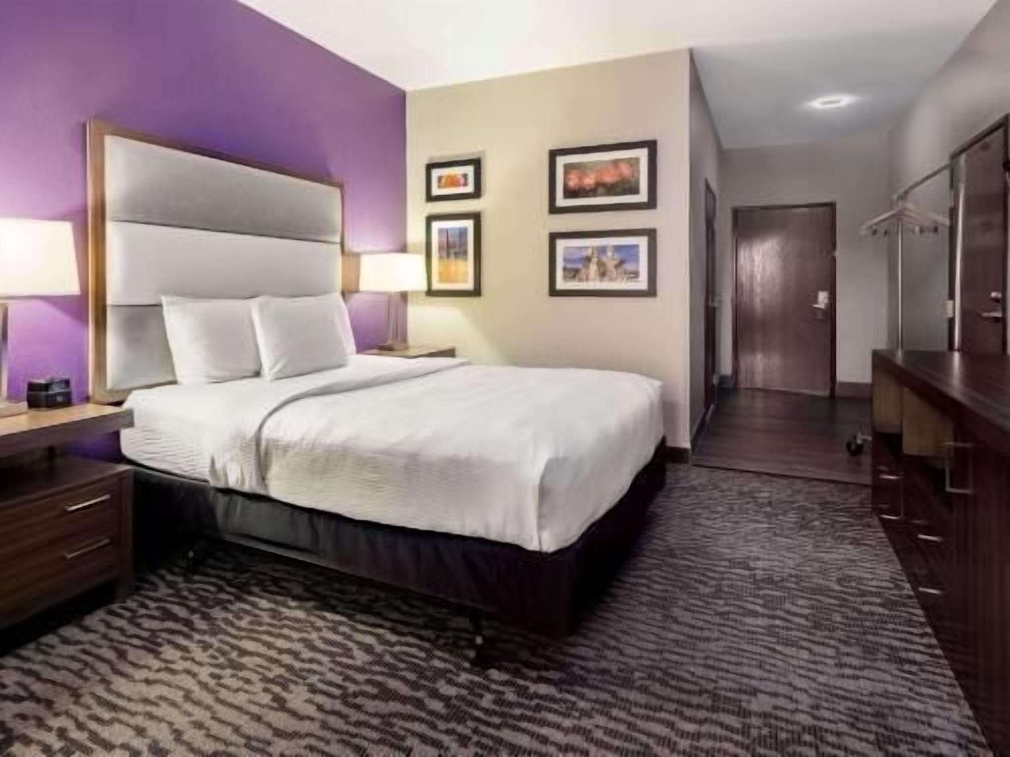 Premium bedding, desk, laptop workspace, blackout curtains