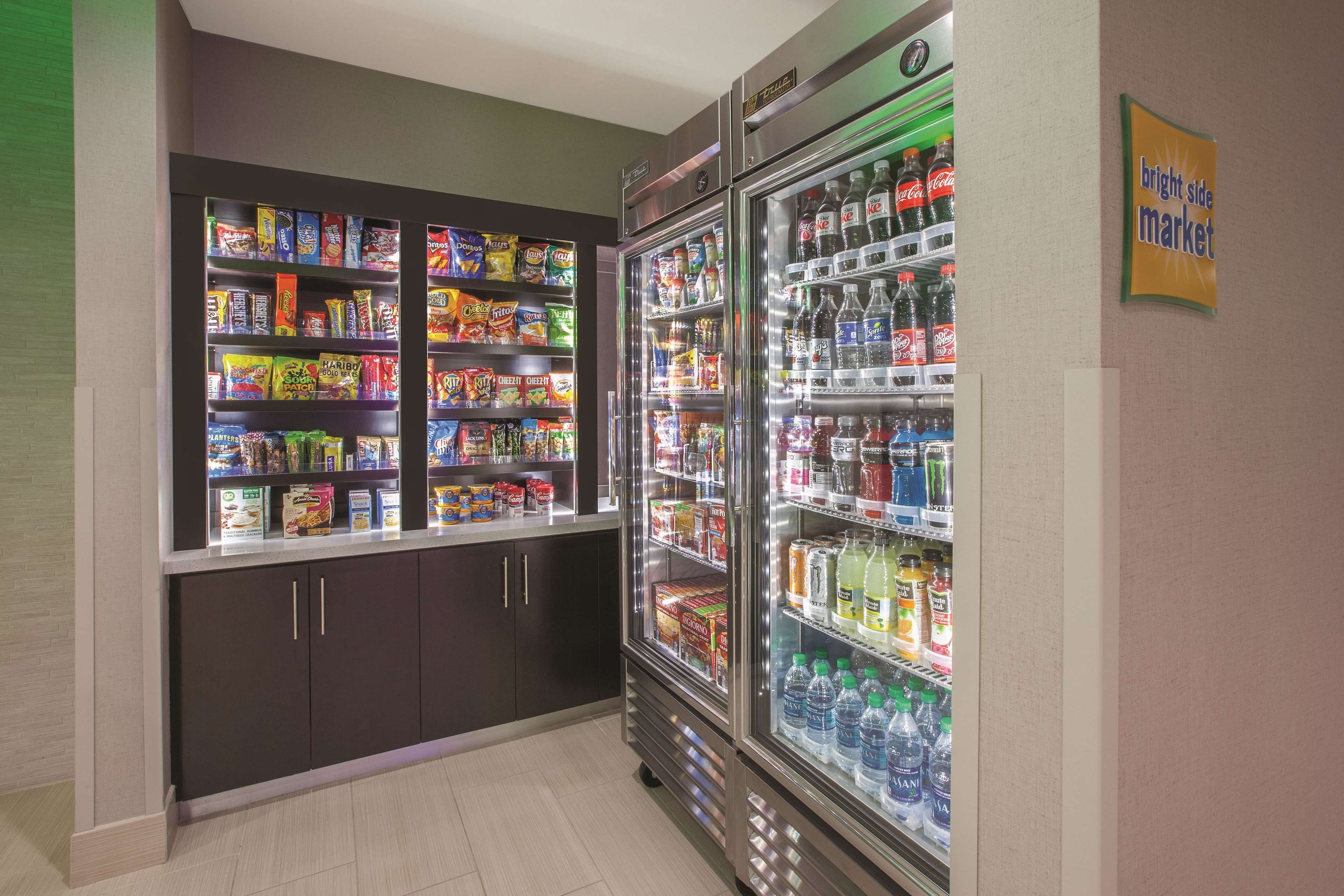 A vending area with snack and drink options, including a refrigerator and a freezer.