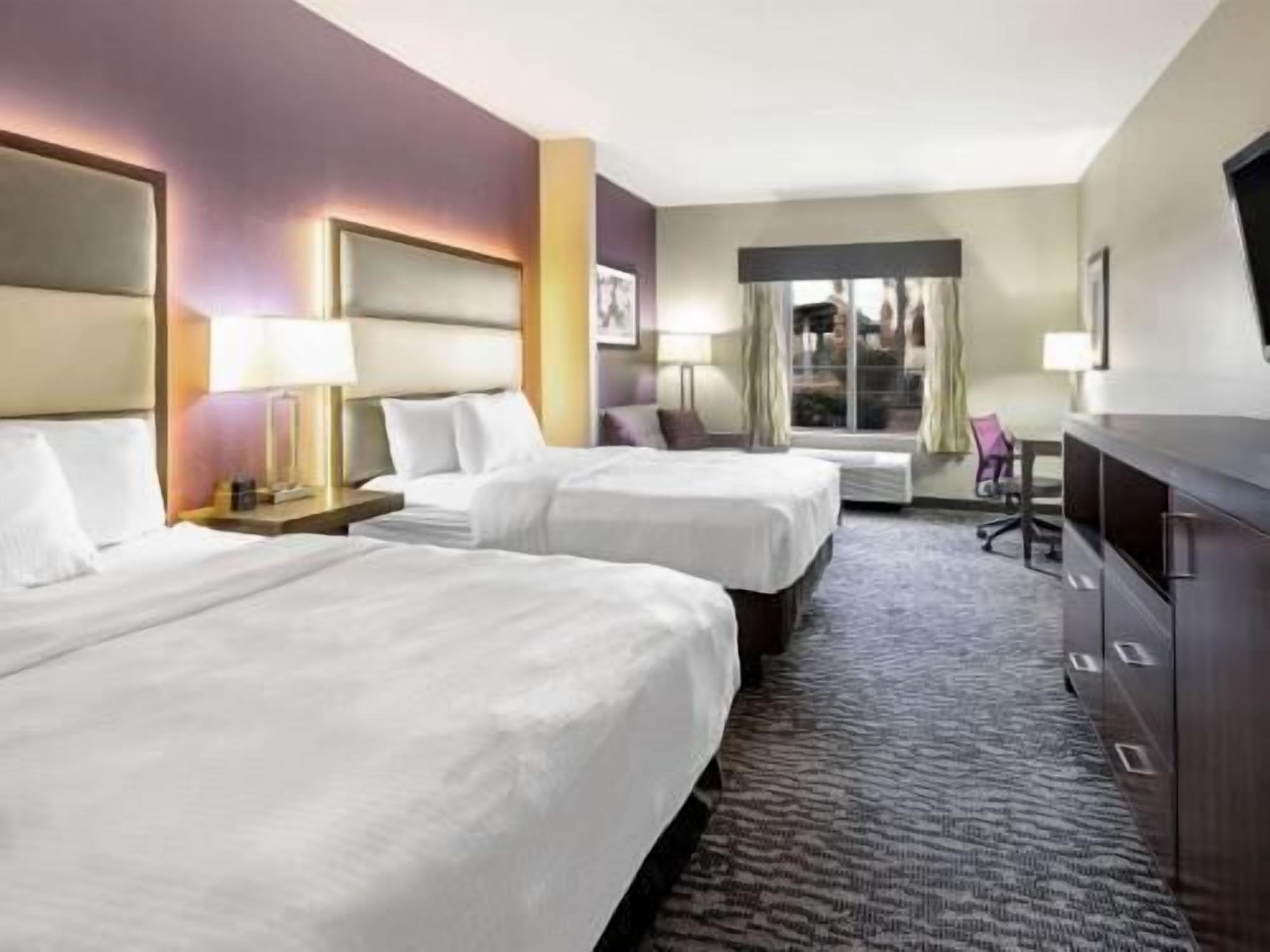 Premium bedding, desk, laptop workspace, blackout curtains