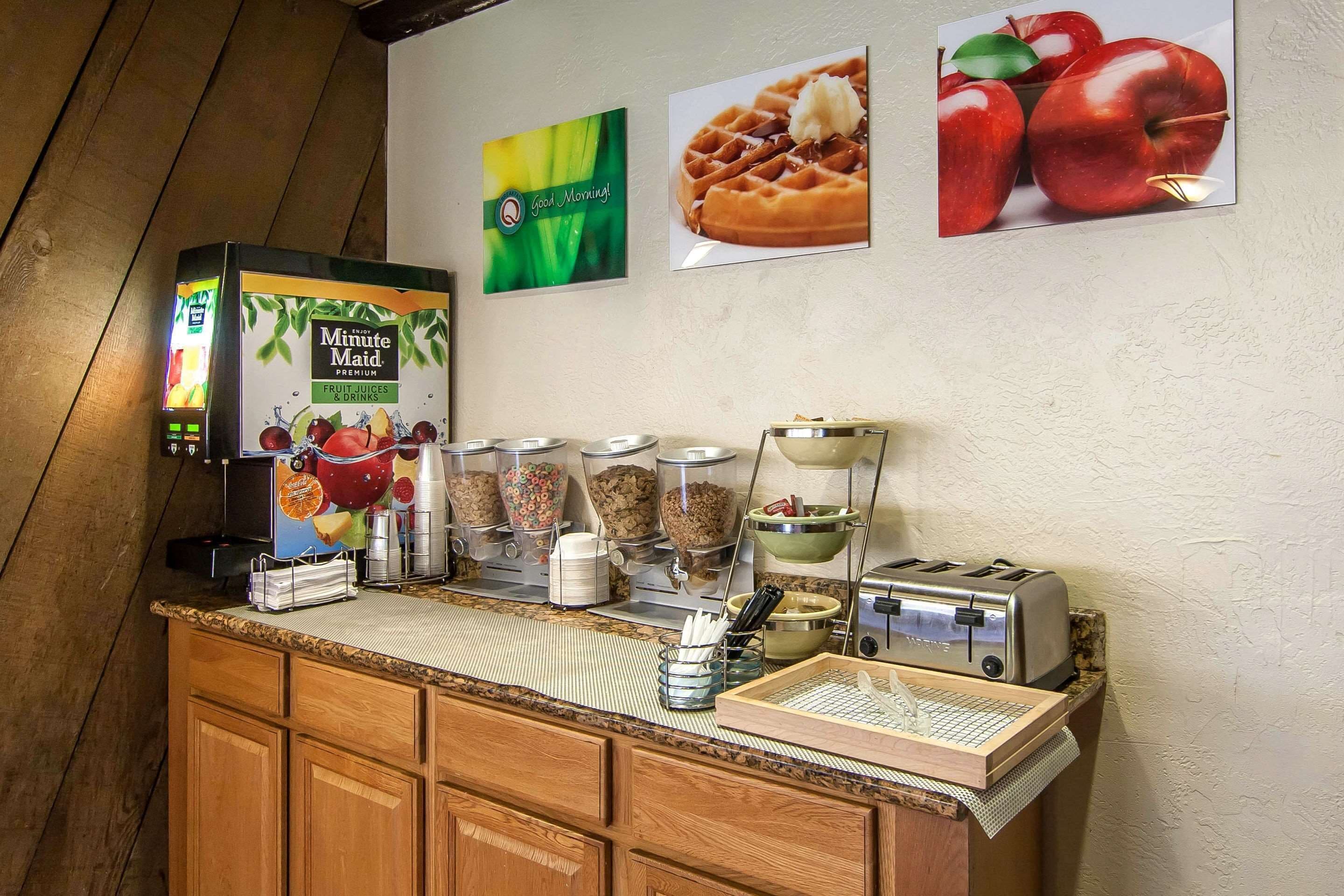 A breakfast bar with a Minute Maid juice dispenser, cereal containers, and a toaster.