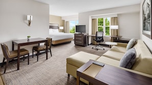 A hotel room with a bed, a desk, a sofa, and a TV. - Residence Inn by Marriott Boston-Franklin (Franklin)