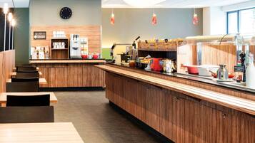 A modern cafe with wooden furniture, a coffee bar, and a clock on the wall.