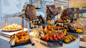 A buffet with roasted meats, vegetables, and pastries. - Leonardo Plaza Dead Sea (Tamar)