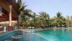 A pool area with lounge chairs and palm trees. - Sofitel Angkor Phokeethra Golf & Spa Resort (Siem Reap)