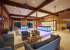 Relax in our inviting lobby, featuring a reception desk, comfortable seating, and a coffee table.