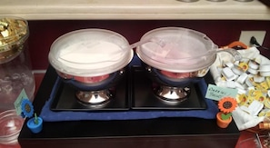 A buffet setup with two covered food dispensers on a blue tray. - Hotel Center 1 (Rome)