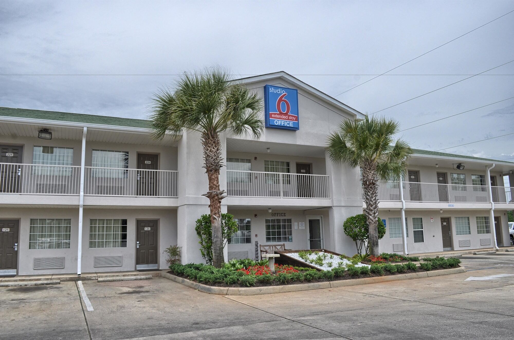 A two-story hotel with a sign indicating it is an extended stay office.