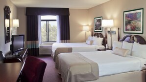 A hotel room with two beds, a desk, a TV, and a window with curtains. - Holiday Inn Allentown-Bethlehem by IHG (Allentown)