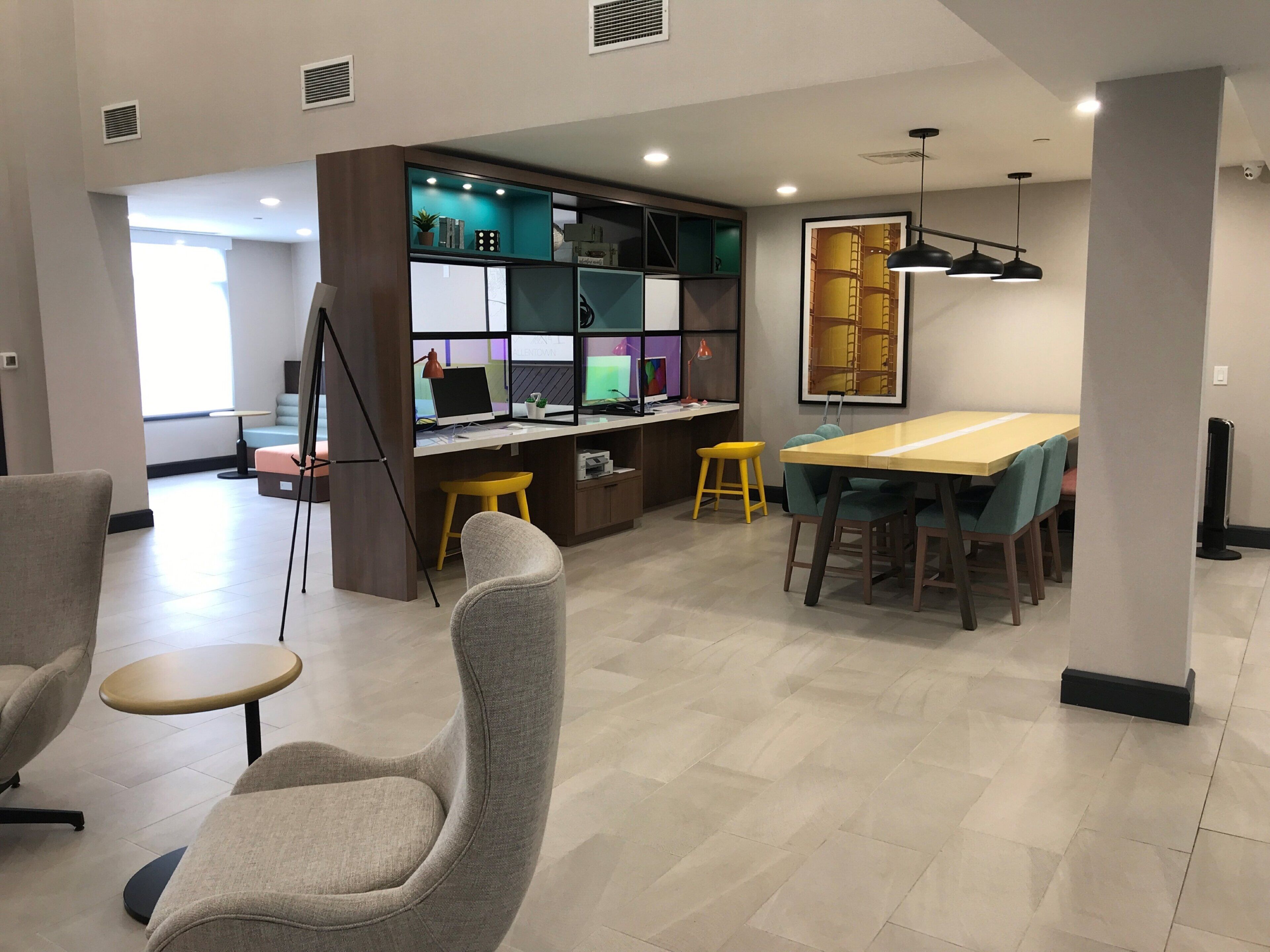 A modern interior with a dining area, seating, and a workspace with a computer.