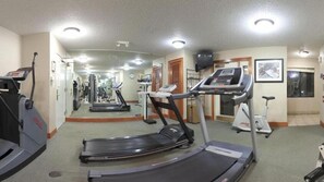 A gym with treadmills, stationary bikes, and a mirrored wall. - Staybridge Suites Detroit-Utica by IHG (Utica)