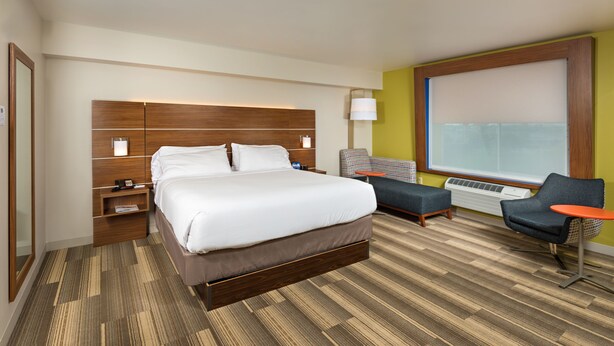A hotel room with a large bed, a desk, a chair, and a window. - Holiday Inn Express Hotel & Suites PEORIA NORTH - GLENDALE by IHG (Peoria)