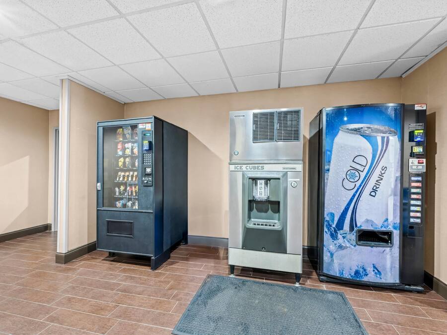 A vending area with a drink dispenser, a water cooler, and a beverage vending machine.