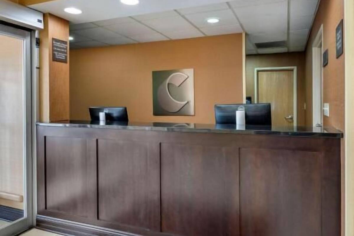 A reception desk with a large, abstract wall art piece above it shows a reception desk with a large, abstract wall art piece above it.
