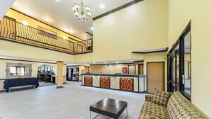 A spacious lobby with a reception desk, a sofa, a coffee table, and a staircase to an upper level. - Quality Inn & Suites Lubbock South (Lubbock)