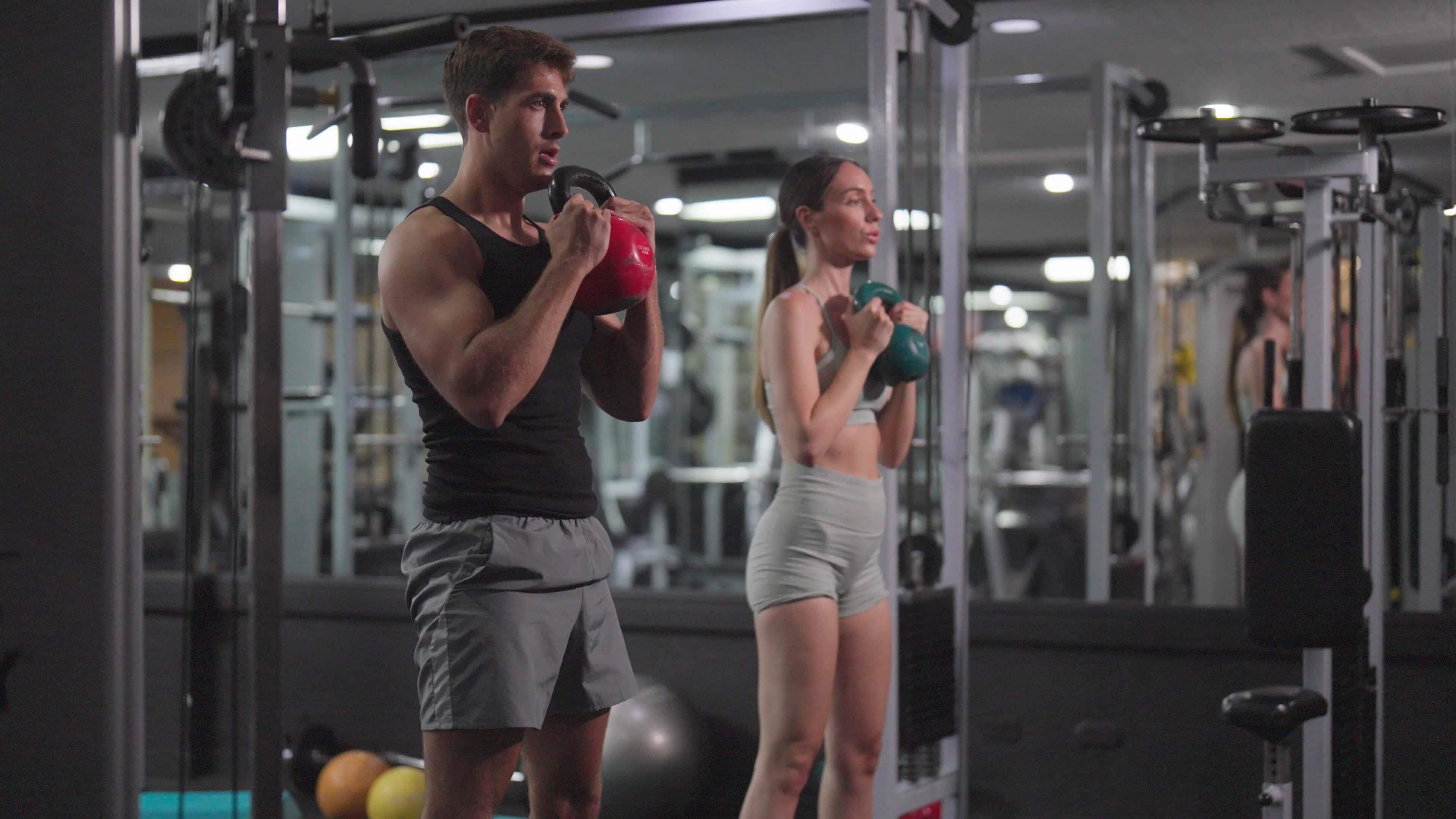 A gym with exercise equipment and a mirror.