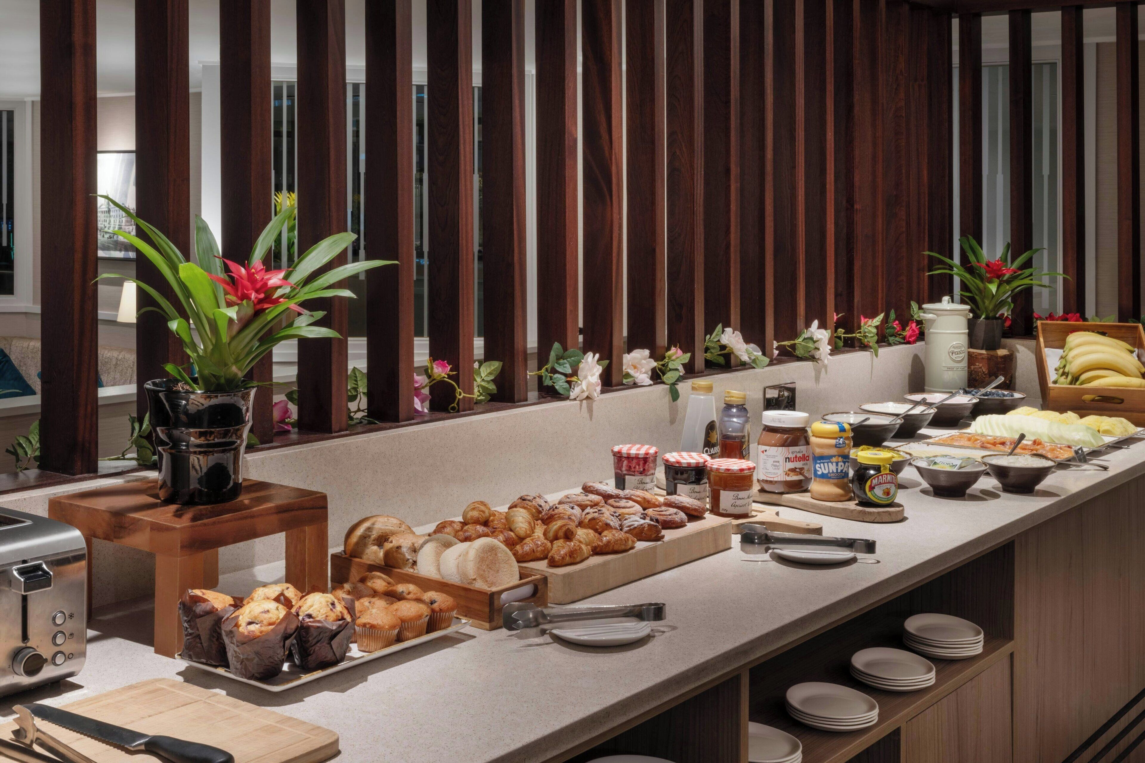 A buffet with various food items and condiments.
