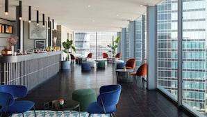 A modern lobby with a bar area, seating arrangements, and large windows offering city views. - Duo Milan Porta Nuova, A Tribute Portfolio Hotel (Milan)