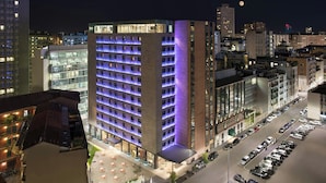 A modern hotel with a prominent corner building, multiple floors, and a parking lot. - Duo Milan Porta Nuova, A Tribute Portfolio Hotel (Milan)