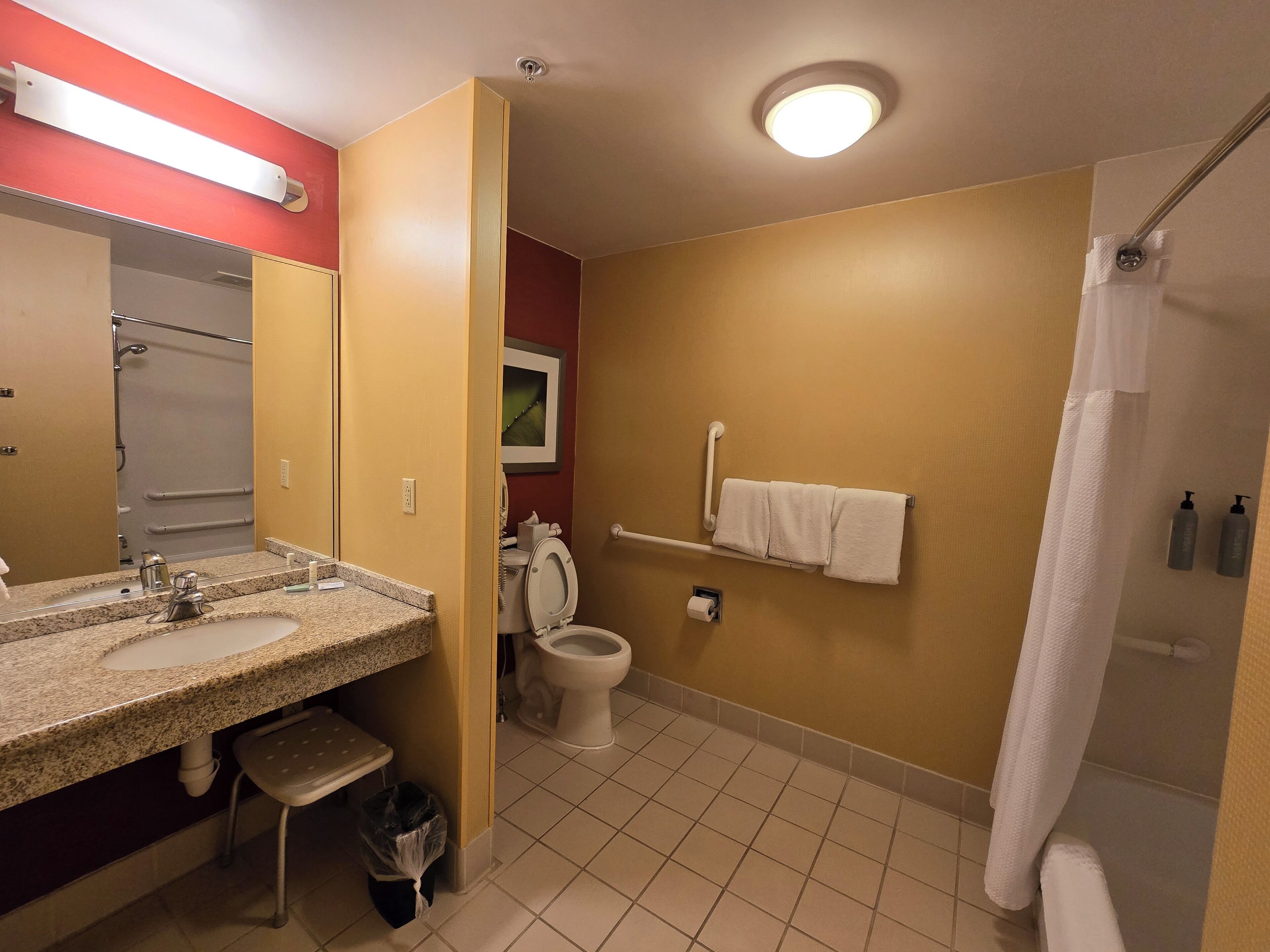 A bathroom with a sink, toilet, and shower.