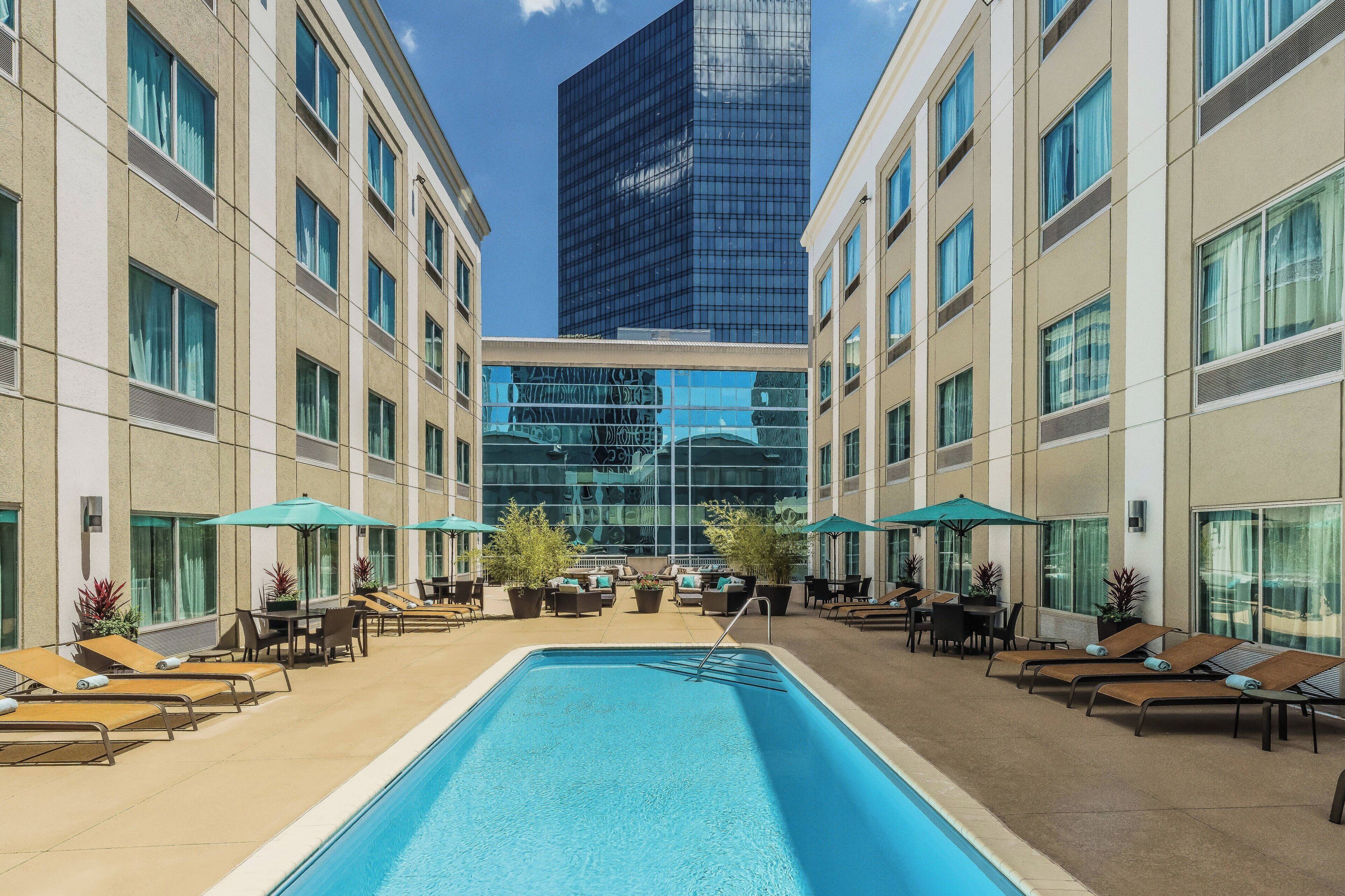 outdoor pool, open 6:00 am to 10:00 pm, pool umbrellas, pool loungers