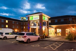A Holiday Inn Express hotel with a parking lot, marked handicapped spaces, and a brick facade. - Holiday Inn Express Southampton - West by IHG (Southampton)