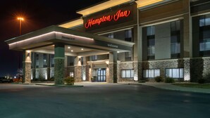 A Hampton Inn hotel with a modern facade, a well-lit entrance, and a clear view of the front door. - Hampton Inn Mitchell (Mitchell)