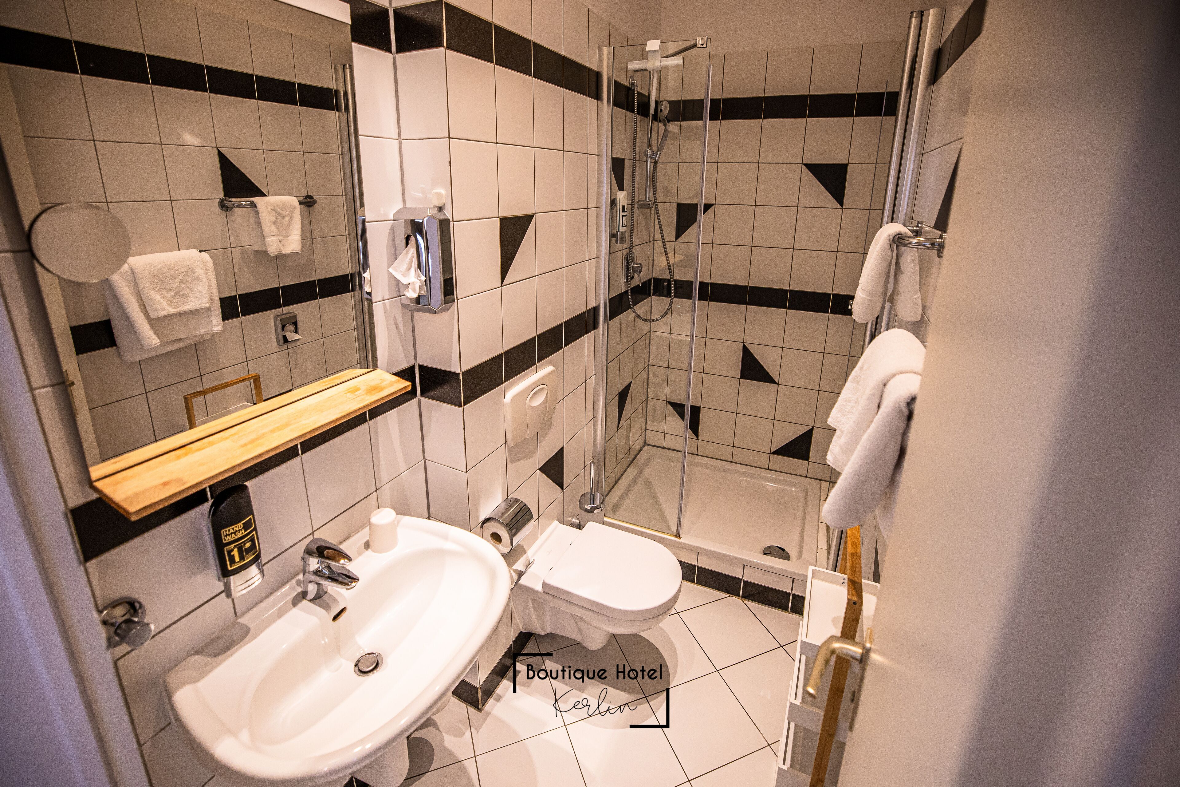A modern bathroom with a sink, toilet, and shower.